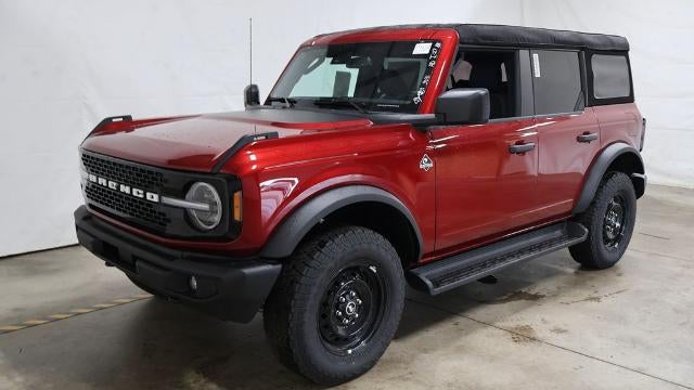 2026 Ford Bronco Outer Banks in Ruby Red Metallic Tinted Clearcoat — front three-quarter view