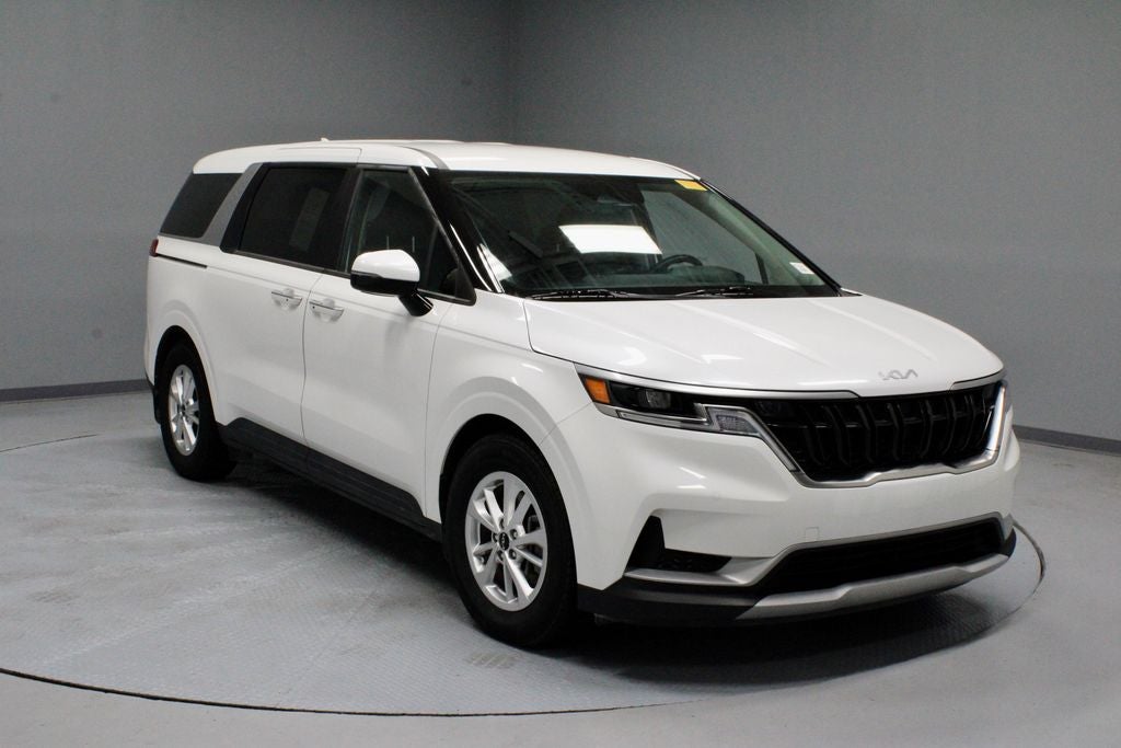 2023 Kia Carnival LX in Snow White Pearl — front three-quarter view
